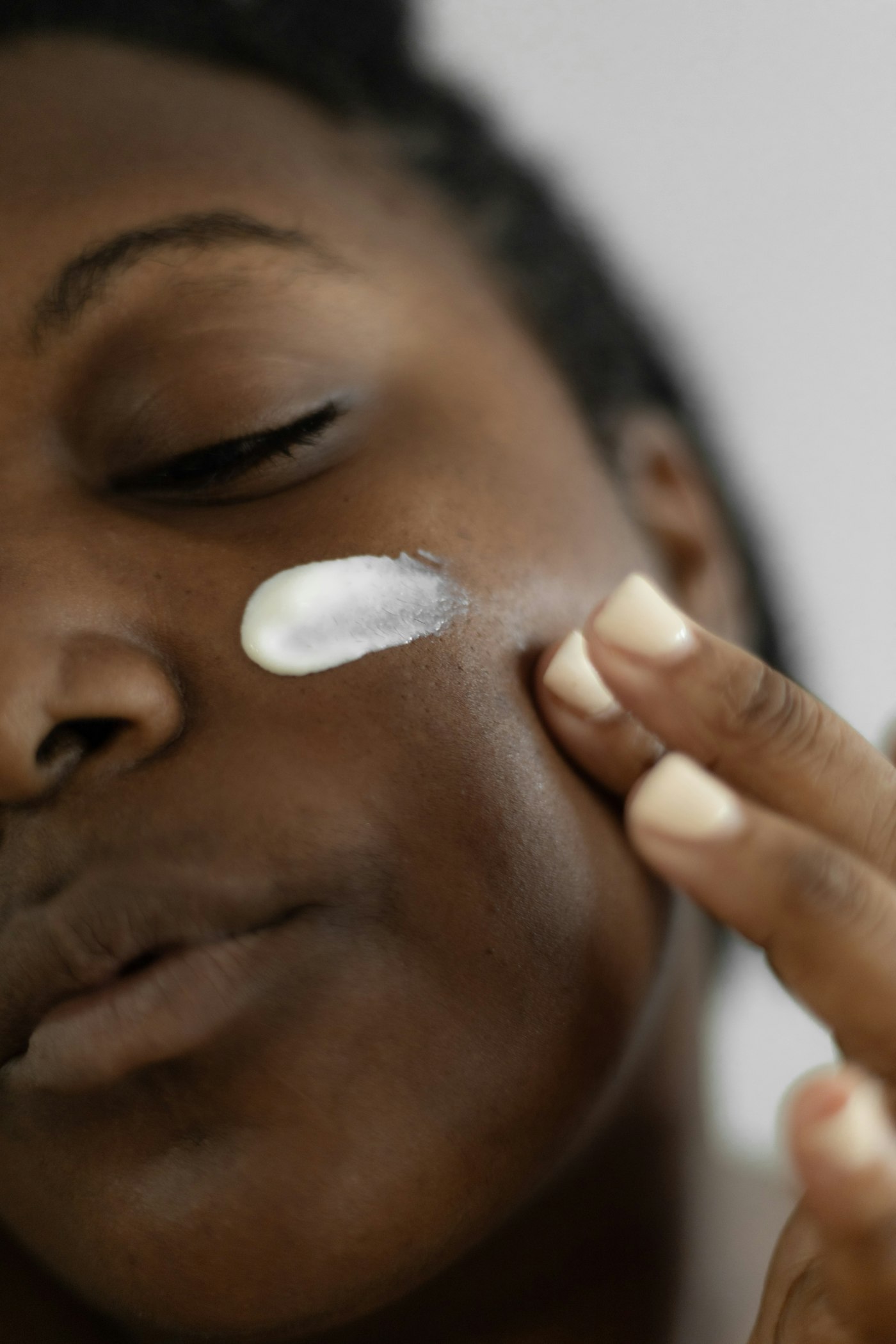 Applying moisturiser to the cheek