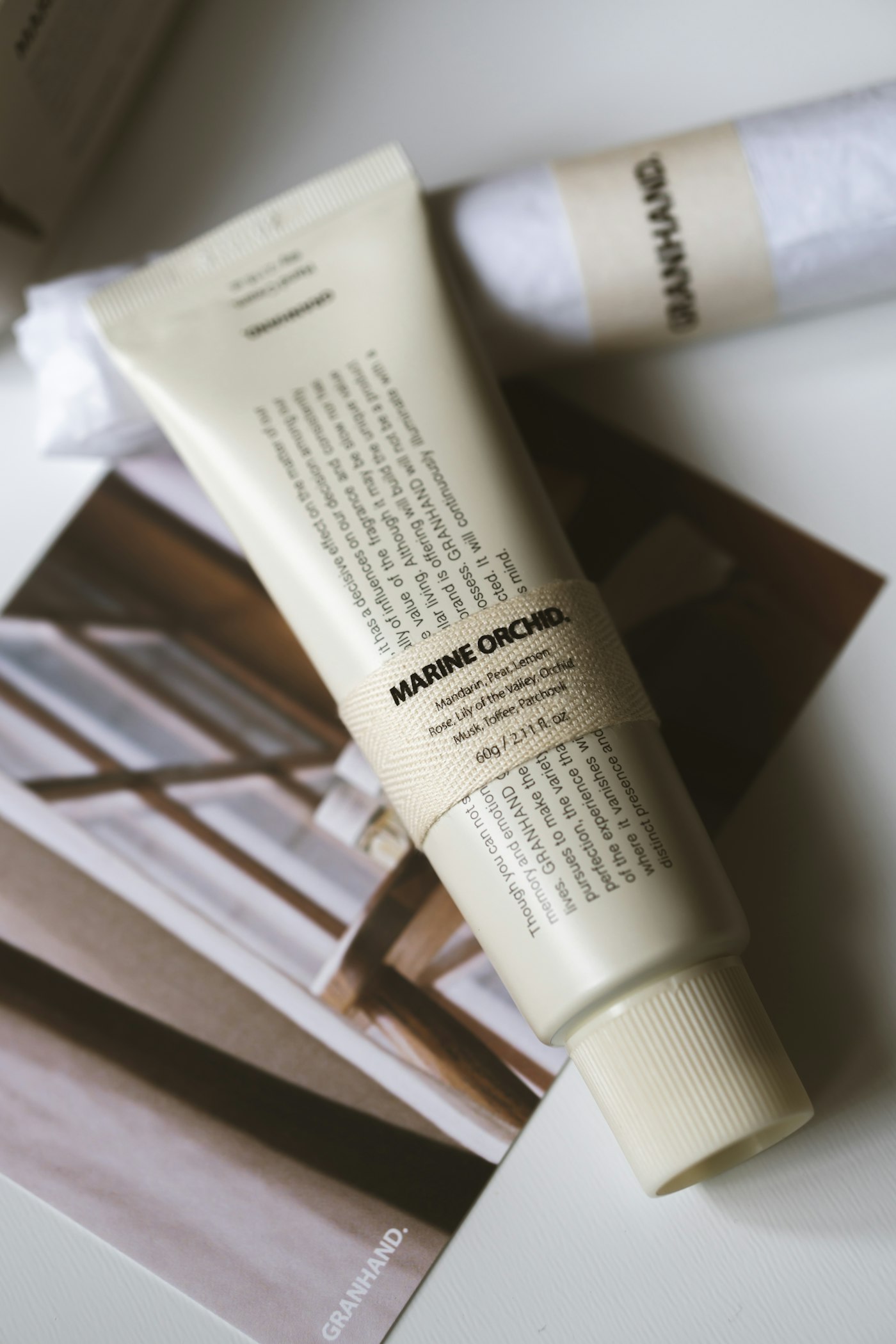 Skincare tube resting on a magazine